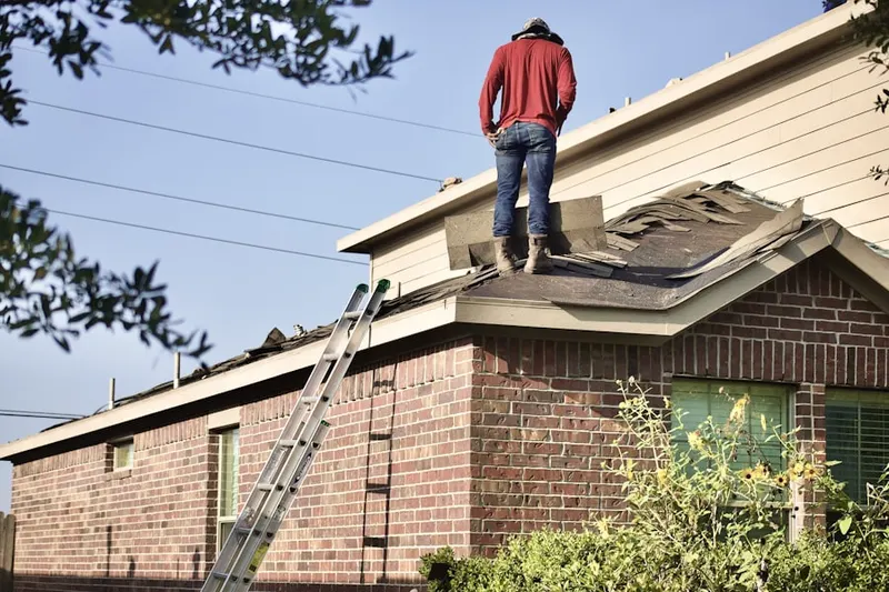 Professional roofer working on a residential roof in Harbor Isle